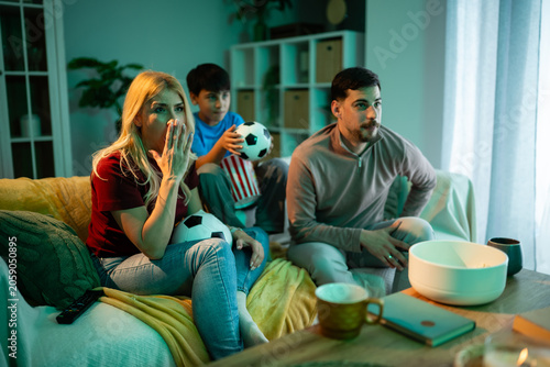 Fotografie Family watching football match at home showing disappointment