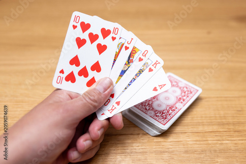 Fotografie Woman's hands holding a fan of playing cards — card game, leisure, entertainment