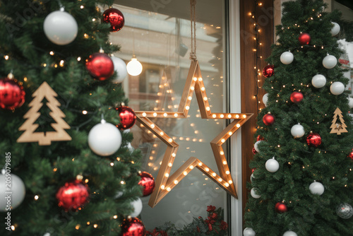 Christmas window display with lighted star and decorated trees, christmas