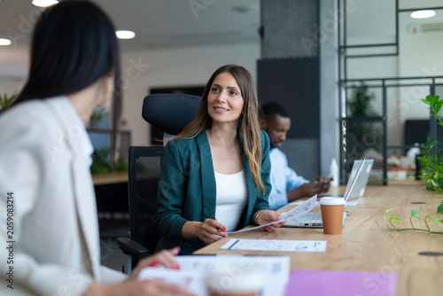 Businesswoman talking with colleague during office meeting