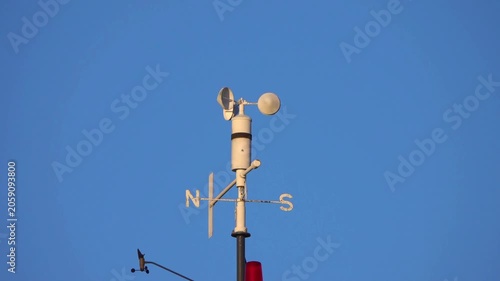 White Anemometer Wind Speed Sensor Spinning Against Clear Blue Sky, Meteorological Weather Station