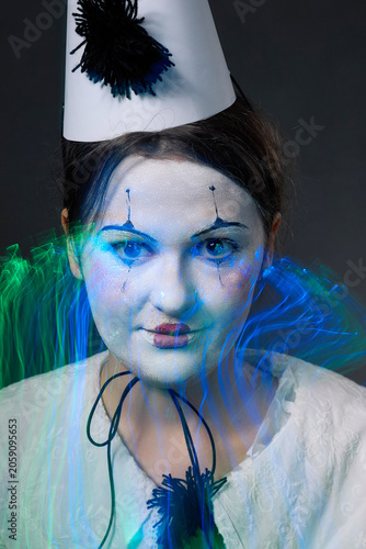 Clown woman close up portrait with creative blue neon light trails effect