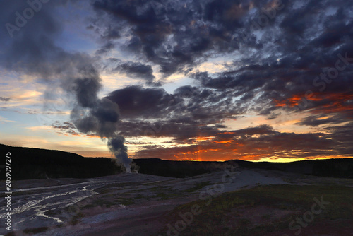 Sun Rising over Old Faithful Geyser in Yellowstone National Park