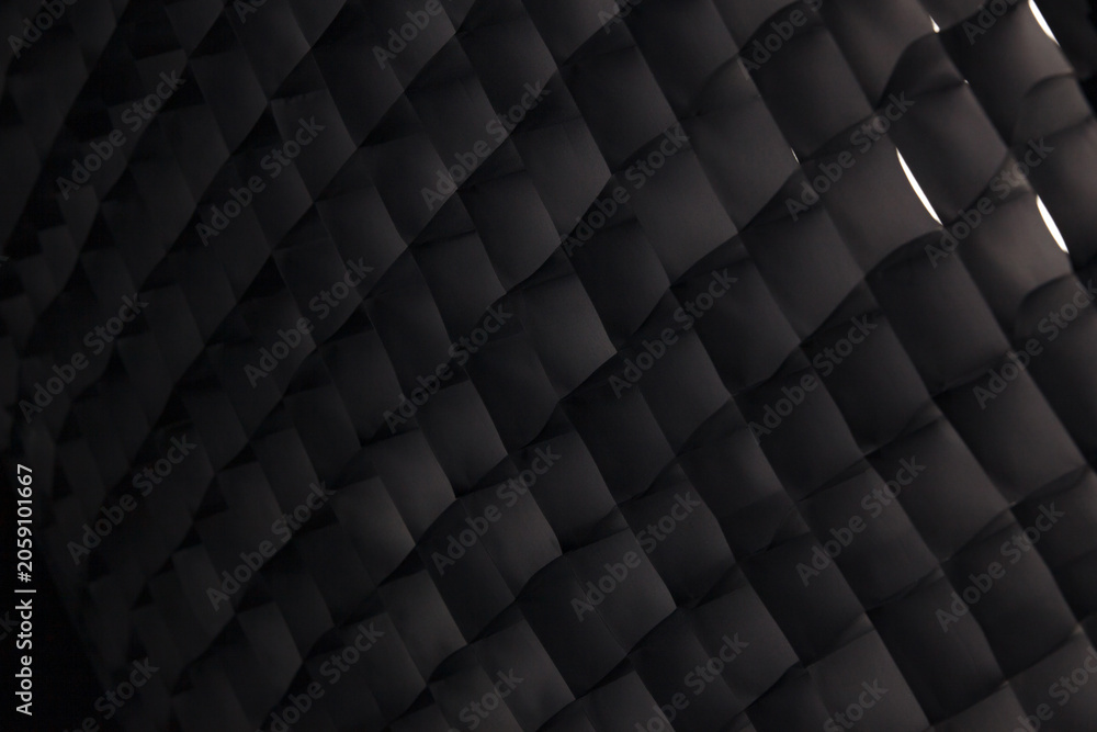 Fototapeta premium Macro of a dark photography studio softbox honeycomb grid abstract pattern.