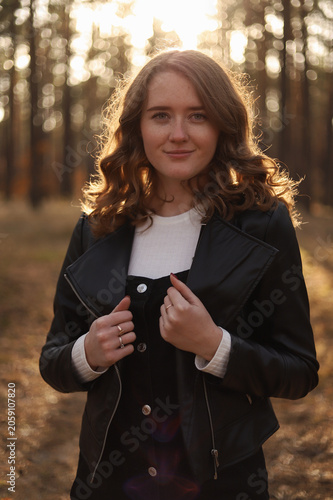 Romantic portrait of a girl in a pine forest