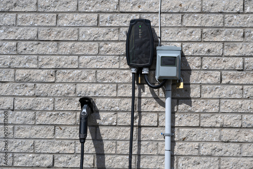 Electric vehicle charger on a brick wall