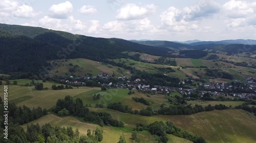 Aerial view of EuroVelo 11 bike path along Poprad river in summer, drone shot of scenic cycling route between Krynica-Zdroj, Muszyna and Rytro in Beskid Sadecki mountains, Poland.