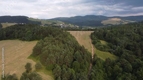 Aerial view of EuroVelo 11 bike path along Poprad river in summer, drone shot of scenic cycling route between Krynica-Zdroj, Muszyna and Rytro in Beskid Sadecki mountains, Poland.