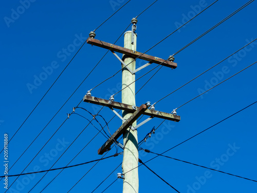 Photograph of the top section of an old and weathered wooden telephone pole in a regional town in the Blue Mountains in New South Wales, Australia
