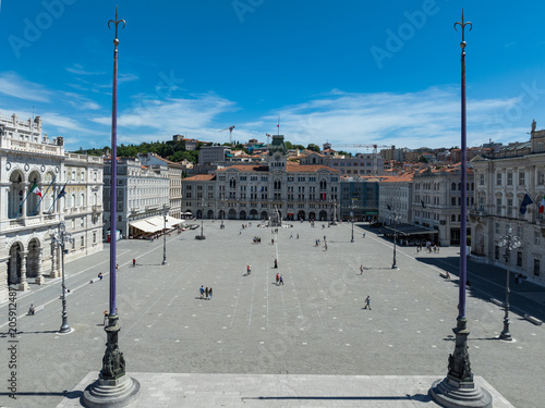 Trieste, Italy - June 2026: Symmetrical high angle view of Piazza Unita d'Italia square and the City Hall between historic flagpoles
