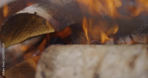 Bright orange flames rising over a dark burning surface