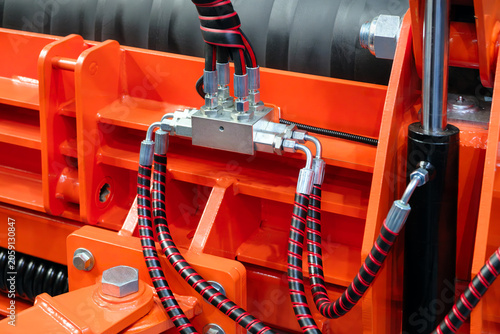 Bild auf Leinwand Part of a hydraulic industrial machine, control levers of a hydraulic machine, industrial  High pressure hydraulic hose system connected to steel pipes, close-up