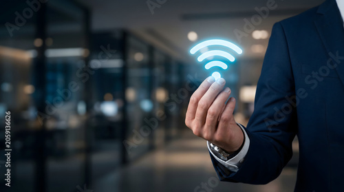 Wireless Network Connectivity Icon Held by Businessman in Modern Office, WiFi Communication and Digital Connection Technology Concept