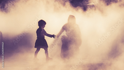 Children and people playing in a mystical fog at sunset