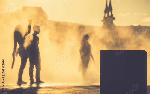 Children and people playing in a mystical fog at sunset