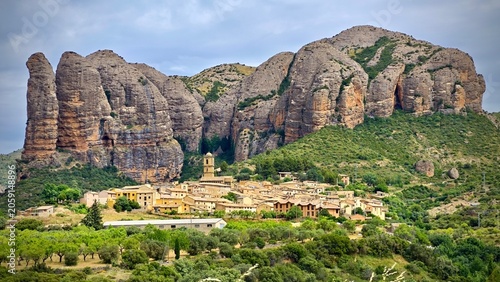 Foto A picturesque view of the village of Agüero in Spain, positioned at the base of the impressive Mallos de Agüero rock formations