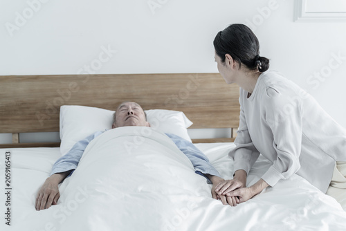 Bild auf Leinwand 寝たきりの高齢者を看病する女性