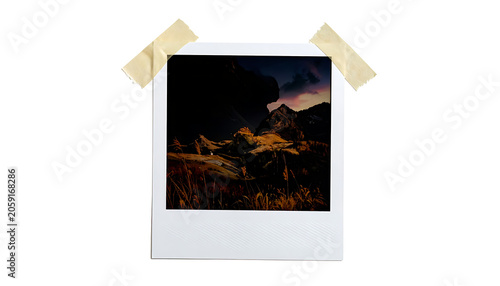 Instant photo frame with tape holding a dark nature landscape, vintage memories, film photography, nostalgic mood