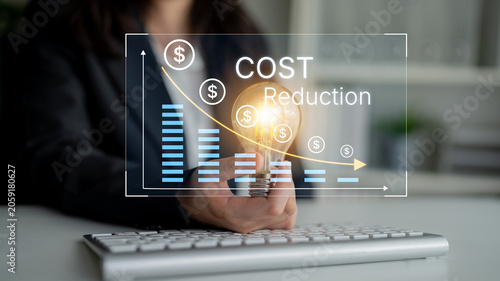 Foto Businessperson Holding Light Bulb with Cost Reduction Concept and Graph Data in Modern Office Environment for Financial Growth and Strategy Development