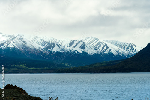 Snow-Capped Peaks Over Lake in Alaska