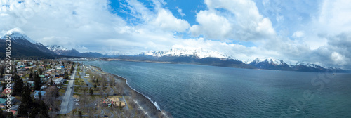 Alaskan Coastal Town Under Snowy Peaks