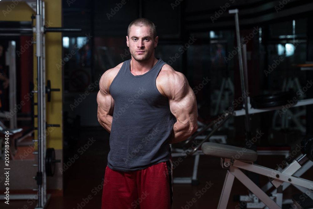 Fototapeta premium Young Bodybuilder Flexing Muscles