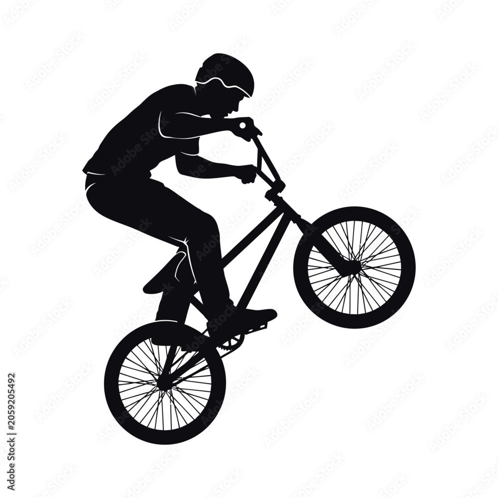Naklejka premium Silhouette of a young cyclist performing a trick on bike