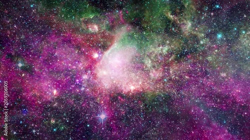 Space Nebula Fly Through 4K Loop features a view flying through the stars into a multicolored nebula in space in a loop.