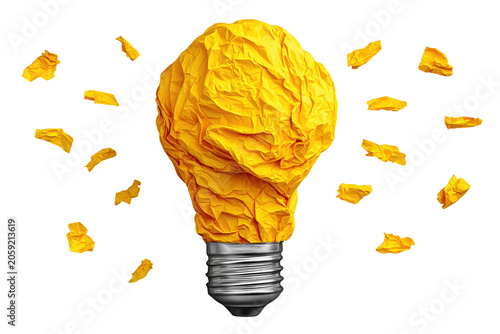 Crumpled yellow paper lightbulb with scattered pieces on black