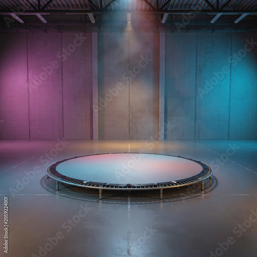 Trampoline sits centered on the floor of a dark warehouse illuminated by vibrant blue and purple neon spotlights.
