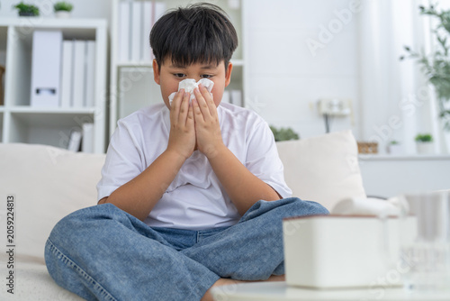Εκτύπωση καμβά Young asian boy sneezing or blowing his nose and mouth with tissue, cold allergi