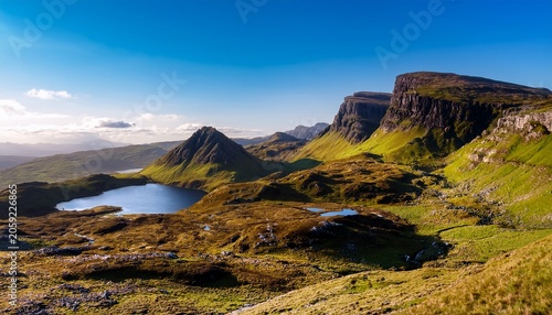 Rugged Hills And Lakes Of Trotternish Escarpment In Isle Of Skye Scotland Under Clear Skies