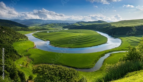 A Winding River Surrounded By Green Meadows