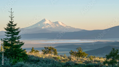 Canvastavla An evening view of Mount Shasta from the north, featuring a shallow lake and low mountains