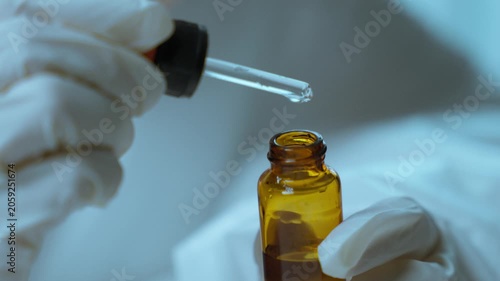 Close-Up of Pharmaceutical Dropper Dispensing Liquid Sample for Laboratory Testing.  Precision testing, laboratory analysis, pharmaceutical science, healthcare innovation