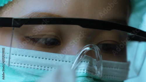 Close-Up of Scientist Concentrating During Pharmaceutical Research Procedure.  Scientific concentration, laboratory precision, pharmaceutical research, healthcare innovation