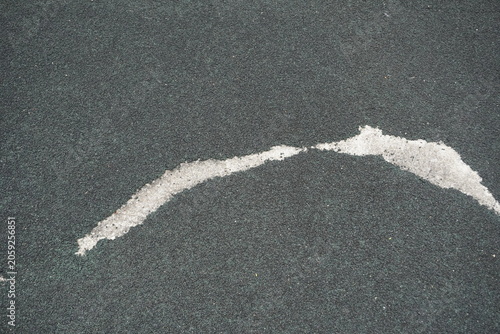 Close-up texture of dark grey asphalt with a white line marking a path