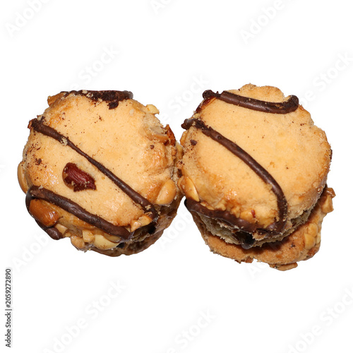 Two round peanut butter cookies with chocolate drizzle and nuts isolated on white
