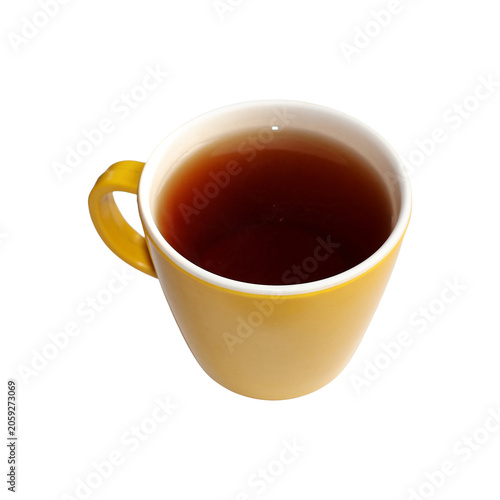 Yellow ceramic mug filled with hot black tea during a warm morning light