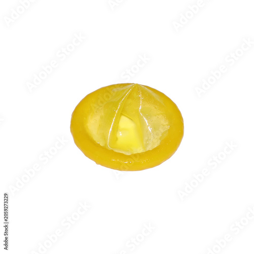 Yellow latex condom with lubricant close-up studio lighting conceptual health safety