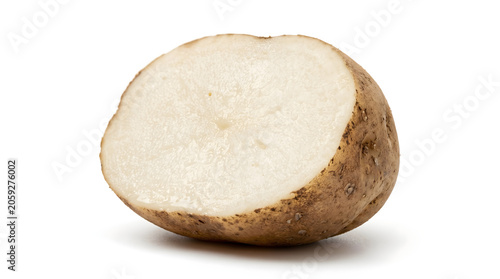 Freshly cut raw russet potato half showing white flesh on white background