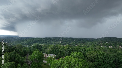 Powerful Thunderstorm Rain Core Over Forested Residential Landscape
