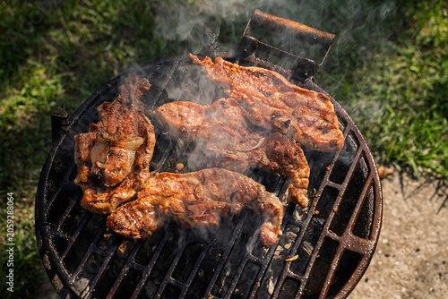 Top view of fresh pork meat grilling on barbeque 