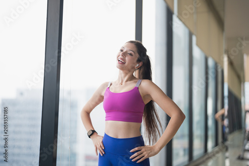 Portrait of Healthy Young Hispanic Gen Z Woman in Sportswear at Gym Embracing Wellness and Self-Love.