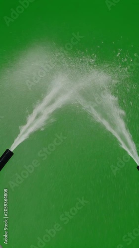 Dynamic twin water jets spraying upwards on green screen, representing cleansing, purity, and powerful flow, symbolizing renewal and refreshing moments