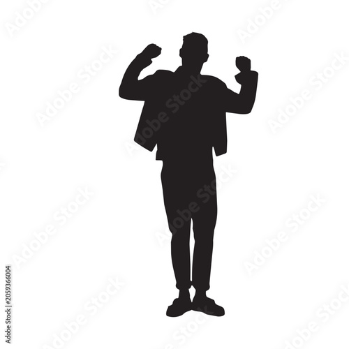 Silhouette of a young man celebrating victory with clenched fists raised high.