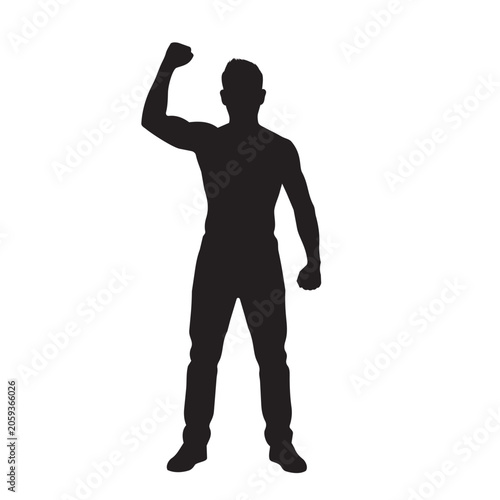 Silhouette of a man standing with a clenched fist raised high