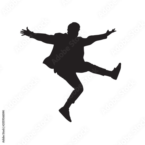 Silhouette of a happy man jumping in the air with his arms spread wide and legs kicked out.
