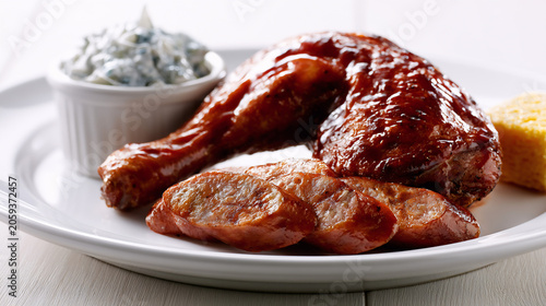 Smoked barbecue chicken leg quarter platter with jalapeno cheddar sausage and sides