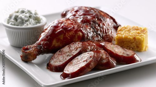 Smoked barbecue chicken leg quarter platter with jalapeno cheddar sausage and sides